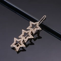 Close-up of golden hair clip with three sparkling rhinestones stars on black surface - Gold Three Pentagrams Rhinestone Frog Clip
