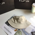 Minimalist beige cotton bucket hat with wide brim, displayed flat on a tabletop - 5.5cm Brim/No Windproof Rope / Beige