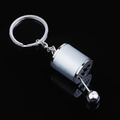 Detail shot of a silver manual gear shifter keychain on a black reflective surface - Silver Gear Shifter