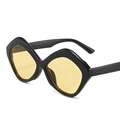 Irregular geometric sunglasses with black frame and amber yellow lenses in side view - Black Frame Yellow Lens