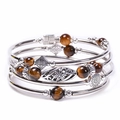 Detailed macro of vintage bohemian multi-layer silver bracelet with brown tiger eye beads - Tiger Eye Style