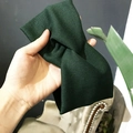 Dark green knitted ribbed wide headband with a stylish central knot design - Cross / Dark Green