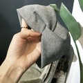 Light gray knitted sports headband with a twisted knot design and ribbed texture - Cross / Light Gray