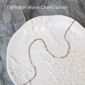 Macro shot of silver water wave chain necklace in a decorative white porcelain dish - Water Wave Chain / 45 cm / Silver