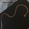 Detail of a thin gold cuban chain necklace with lobster clasp on a dark background - Link Chain / 45 cm / Gold