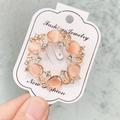 Broche ajourée en or rose avec pierres d'opale rose et cristaux scintillants - A7-6
