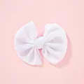 Soft pearlized white velvet bow hair clip for children on a pastel pink background - White
