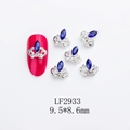 Macro view of crown-shaped nail charms with blue K9 rhinestones and 9.5x8.6mm dimensions - Crown-LF2933 / Silver/Blue