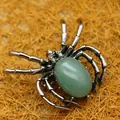 Silver spider pendant brooch with green aventurine stone inlay on textured background - Aventurine Jade
