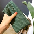 Handheld dark green ribbed knit headband featuring a stylish crisscross knot design - Flat Band / Dark Green