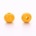 Close-up of vibrant yellow round wooden beads with smooth finish for DIY jewelry crafts - Turmeric