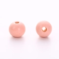 Close-up of light pink round wooden beads showing central hole for DIY jewelry making - Pink