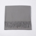 Folded medium grey cashmere-like scarf with fringe tassels on white background - Medium Grey