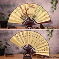 Traditional 10-inch hand-painted folding fan featuring plum blossom and bamboo artwork - 10-Inch Plum and Bamboo