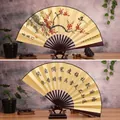 Traditional Chinese folding fan featuring hand-painted plum blossoms and calligraphy - 10-Inch Joy Entering the Door