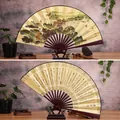 Classic 10-inch landscape folding fan with gold finish and wooden display stand - 10-Inch Spring in the World
