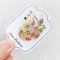 Elegant gold swan brooch with colorful rhinestones on a white display card - A7-23