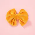 Soft velvet bow hair clip for girls in bright yellow on a pastel pink background - Yellow