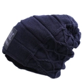 Detailed macro view of dark blue winter beanie showing knit texture and fabric label - One Size / Navy Blue