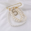Elegant gold safety pin brooch with layered pearls and sparkling crystal number 5 charm - Gold