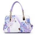 White floral women's handbag with purple handles and detachable strap in a studio shot - Purple Orchid