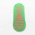 Green cotton yoga socks featuring orange non-slip silicone grip dots on the sole - Green