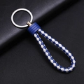 Portachiavi in pelle intrecciata blu e bianca con anello in metallo su sfondo scuro - 30*1.6mm / Blu Scuro Bianco