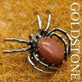 Silver spider brooch pendant featuring an oval brown goldstone with shimmering details - Gold Sandstone