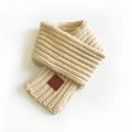Beige ribbed knit scarf for women with brown leather label in a folded minimalist style - Beige / 100-135