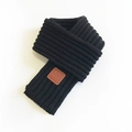 Women's minimalist black knitted short scarf featuring a brown EST MOVE leather patch - Black / 100-135