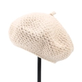 Detail of beige hand-knitted beret cap featuring chunky crochet texture and top loop - M (56-58cm) / Beige