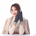Detail of grey winter knit gloves featuring black and white plaid cuffs and button accents - Grey With Black And White Grid