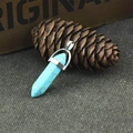 Natural hexagonal turquoise bullet stone pendant with silver metal bail on rustic fabric - Green Turquoise