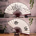 Bamboo folding fan with orchid ink painting and calligraphy shown on a wooden stand - 10 Inch Fragrant Orchid