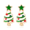 Close-up of golden Christmas tree earrings with white enamel and sparkling rhinestones - White Christmas Tree