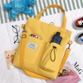 Yellow canvas crossbody tote bag with adjustable strap and front pocket detail - Multi-use Water Cup Position / Yellow