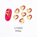 Macro shot of 9x9mm heart-shaped gold alloy nail charms with red rhinestones and crown detail - Heart Shape (LF3020) / 1 Piece