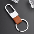 Brown litchi grain leather keychain with silver metal D-ring on dark textured background - Brown Litchi Pattern Style (GX-171)
