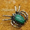 Spider brooch pendant featuring an oval malachite stone with green and black stripes - Malachite