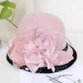 Detail of pink wool felt fascinator hat with silk flowers, feathers and mesh veil accents - Taro Purple