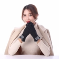 Detailed view of warm black gloves with plush grey cuffs and decorative bow for winter - Black Fur Cuff With Bow
