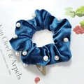 Close-up of dark blue velvet scrunchie featuring elegant white faux pearl embellishments - Blue Pearl