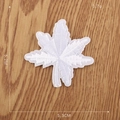 White floral embroidered patch with leaf details on light wood background, 5.2x5.3cm - Precision Embroidered Leaf (5.2x5.3cm)