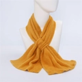 Thick yellow plush scarf for winter shown on a mannequin neck with fringe details - Yellow