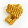 Chunky knit short scarf in yellow with a leather patch featuring EST MOVE branding - Turmeric / 100-135