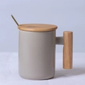 Grey ceramic mug featuring a natural bamboo handle, bamboo lid, and a golden spoon accessory - Cylindrical Grey Mug with Lid & Spoon