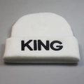 Detailed view of the black KING letter embroidery on the white knitted beanie hat - KING Style / White KING