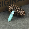 Green hexagonal crystal pillar pendant necklace with silver metal clasp on natural wood - Green Aventurine