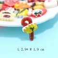 Christmas resin candy cane charm with holly leaf and berry detail for DIY crafts - Red Candy Cane