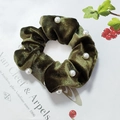Detail of dark green velvet scrunchie with white pearl accents on vintage paper - Green Pearls